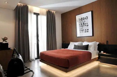 a bedroom with a bed and a large window at The Editor Hotel Athens in Athens