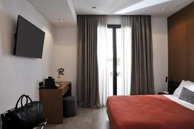 a hotel room with a bed and a large window at The Editor Hotel Athens in Athens