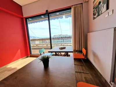 a room with a table and a large window at SleepEasy City center in Athens