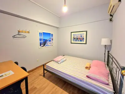 a small bedroom with a bed and a desk at SleepEasy City center in Athens