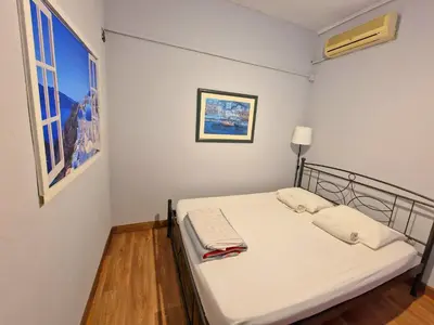 a small bedroom with a bed with white sheets at SleepEasy City center in Athens
