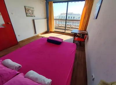 a room with two beds and a large window at SleepEasy City center in Athens