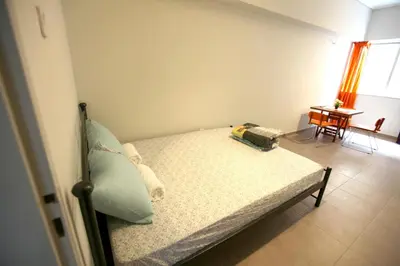 a bedroom with a bed and a table with a table at SleepEasy City center in Athens