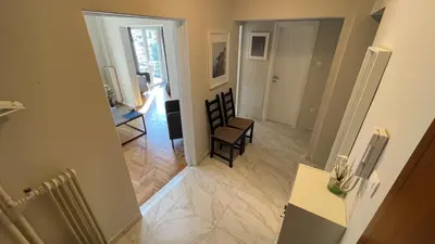 a view of a hallway with a living room at 2 Newly Renovated Charming Apartments steps from Panormou Metro Station in Athens