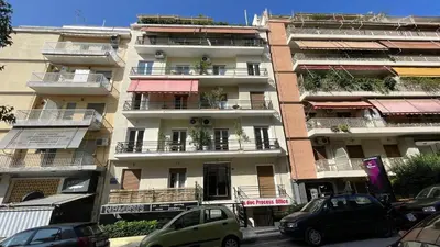 a tall building with cars parked in front of it at 2 Newly Renovated Charming Apartments steps from Panormou Metro Station in Athens