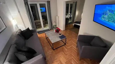 an overhead view of a living room with a couch and a table at 2 Newly Renovated Charming Apartments steps from Panormou Metro Station in Athens