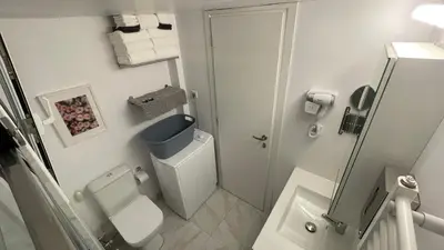 a white bathroom with a toilet and a shower at 2 Newly Renovated Charming Apartments steps from Panormou Metro Station in Athens