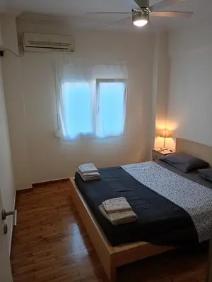 a bedroom with a bed and a window at Omonia Square Apartment in Athens