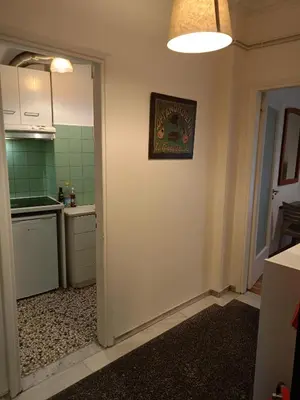 a room with a kitchen with a picture on the wall at Omonia Square Apartment in Athens