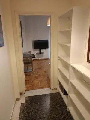 a room with a closet with a television and a desk at Omonia Square Apartment in Athens