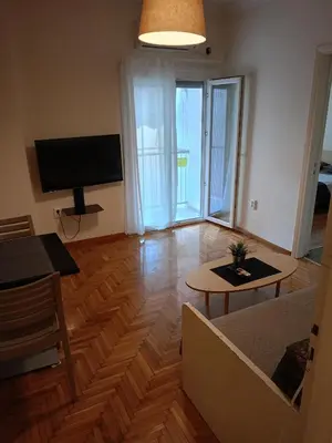 a living room with a couch and a table and a television at Omonia Square Apartment in Athens