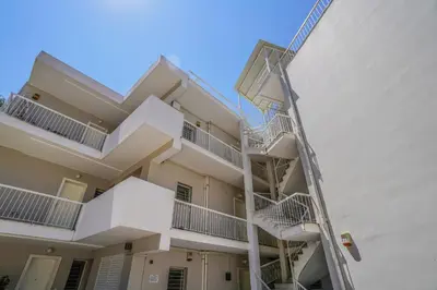 an apartment building with stairs on the side at Bliss Living in Vouliagmeni