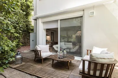 a patio with a table and chairs on a deck at Bliss Living in Vouliagmeni