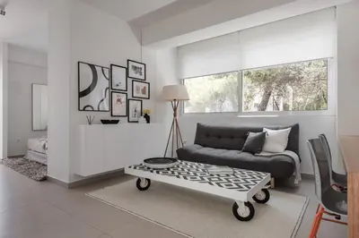 a living room with a couch and a coffee table at Bliss Living in Vouliagmeni