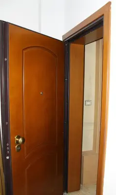 a wooden door and a mirror in a room at Studio NATASHA without PARKING in Athens