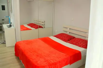 a bedroom with a bed with a red blanket at Studio NATASHA without PARKING in Athens