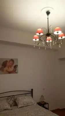 a chandelier with a picture of a woman holding a baby at Acropolis within 10min. walk! in Athens