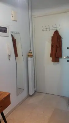 a room with a mirror and a coat hanging on a wall at Acropolis within 10min. walk! in Athens