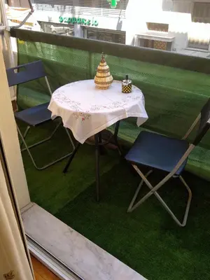 a table with two chairs and a hat on it at Acropolis within 10min. walk! in Athens