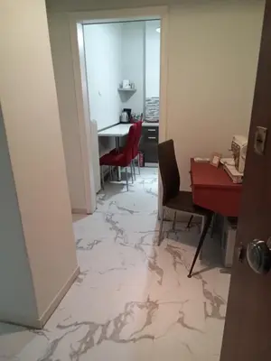 a room with a red table and chairs and a table at Acropolis within 10min. walk! in Athens