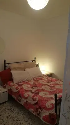 a bedroom with a bed with a red and white blanket at Apartment by Sepolia Metro-Ησυχη γκαρσονιερα κοντα στο Μετρό in Athens
