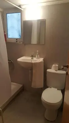 a bathroom with a white toilet and a sink at Apartment by Sepolia Metro-Ησυχη γκαρσονιερα κοντα στο Μετρό in Athens