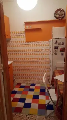 a kitchen with a refrigerator and a colorful floor at Apartment by Sepolia Metro-Ησυχη γκαρσονιερα κοντα στο Μετρό in Athens