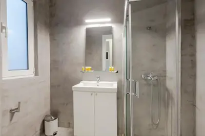 a bathroom with a shower and a sink and a shower at Acropolis Apartments in Athens