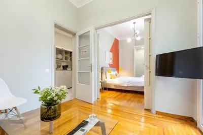 a living room with a television and a bedroom at Acropolis Apartments in Athens