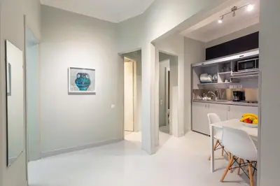 a kitchen and dining room with a table and chairs at Acropolis Apartments in Athens