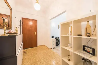 a hallway with white walls and a wooden door at Fresh and Clean apt for 6 in Koukaki in Athens