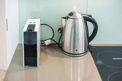 a blender and a phone sitting on a counter at Fresh and Clean apt for 6 in Koukaki in Athens
