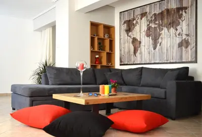 a living room with a couch and a table with red pillows at Athens metro apartment in Athens