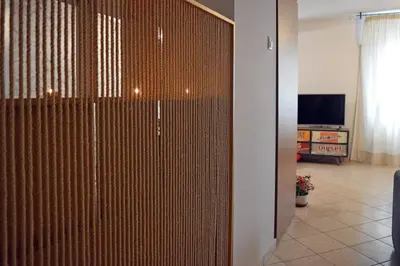 a sliding door in a living room with a television at Athens metro apartment in Athens