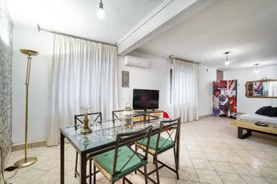 a living room with a glass table and chairs at Athens metro apartment in Athens