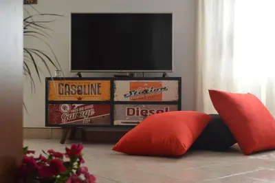a living room with a television and some pillows at Athens metro apartment in Athens