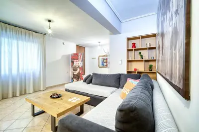a living room with a couch and a table at Athens metro apartment in Athens