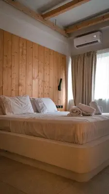 a bedroom with a large bed with a wooden wall at My Athens Place in Athens