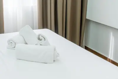 a pile of towels sitting on top of a bed at My Athens Place in Athens