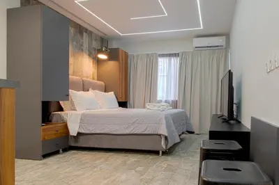 a bedroom with a bed and a flat screen tv at My Athens Place in Athens