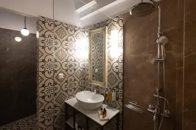 a bathroom with a sink and a shower at ATHENIAN YARD SUITES in Athens