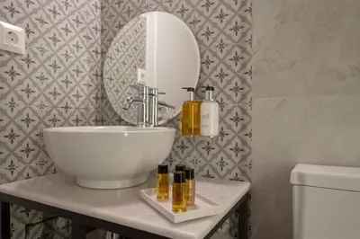 a bathroom with a sink and a mirror at ATHENIAN YARD SUITES in Athens