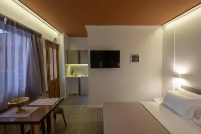 a hotel room with a bed and a dining table at ATHENIAN YARD SUITES in Athens