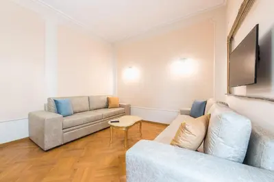 a living room with a couch and a tv at Athens Empire Paradise Apartment in Athens