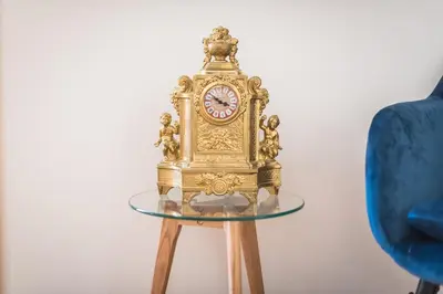 a gold clock sitting on top of a glass table at Athens Empire Paradise Apartment in Athens