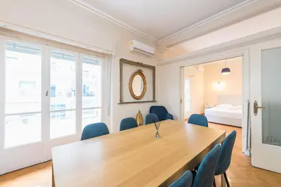 a conference room with a wooden table and blue chairs at Athens Empire Paradise Apartment in Athens