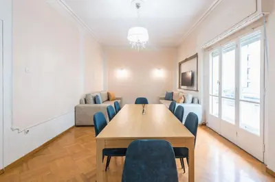 a room with a table and chairs and a couch at Athens Empire Paradise Apartment in Athens