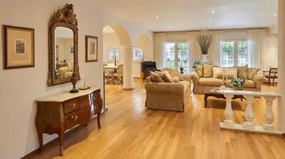 a living room with a couch and a table and a mirror at Luxury 4 Bdrm Villa with Pvt Pool on the beach in Lagonissi