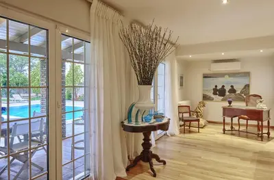 a living room with a vase on a table with a vase at Luxury 4 Bdrm Villa with Pvt Pool on the beach in Lagonissi