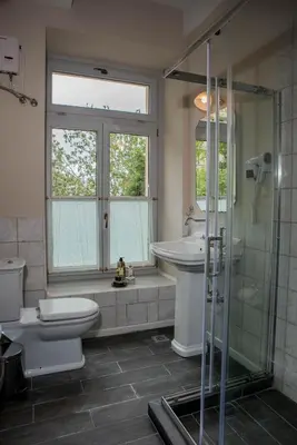 a bathroom with a toilet and a sink and a shower at Kyria Boutique House in Athens